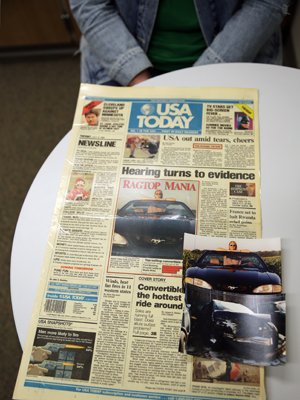 Sara Schreiner poses with the front page of USA Today from July 5, 1994, in which she was featured on the front page for a story about the then new Ford Mustang GT. She had just purchased the car after recovering from a serious car accident.